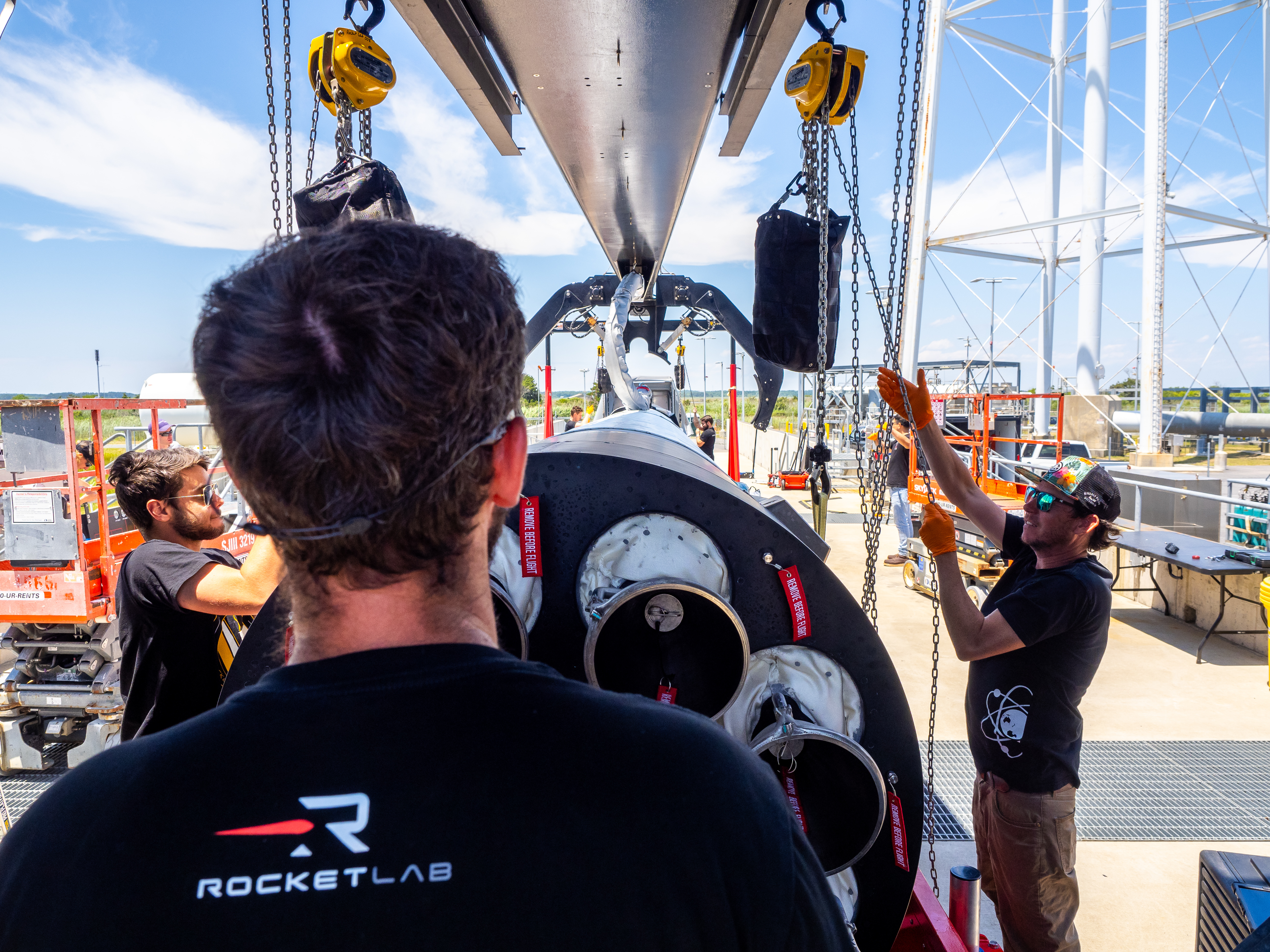 Three men working on a rocket