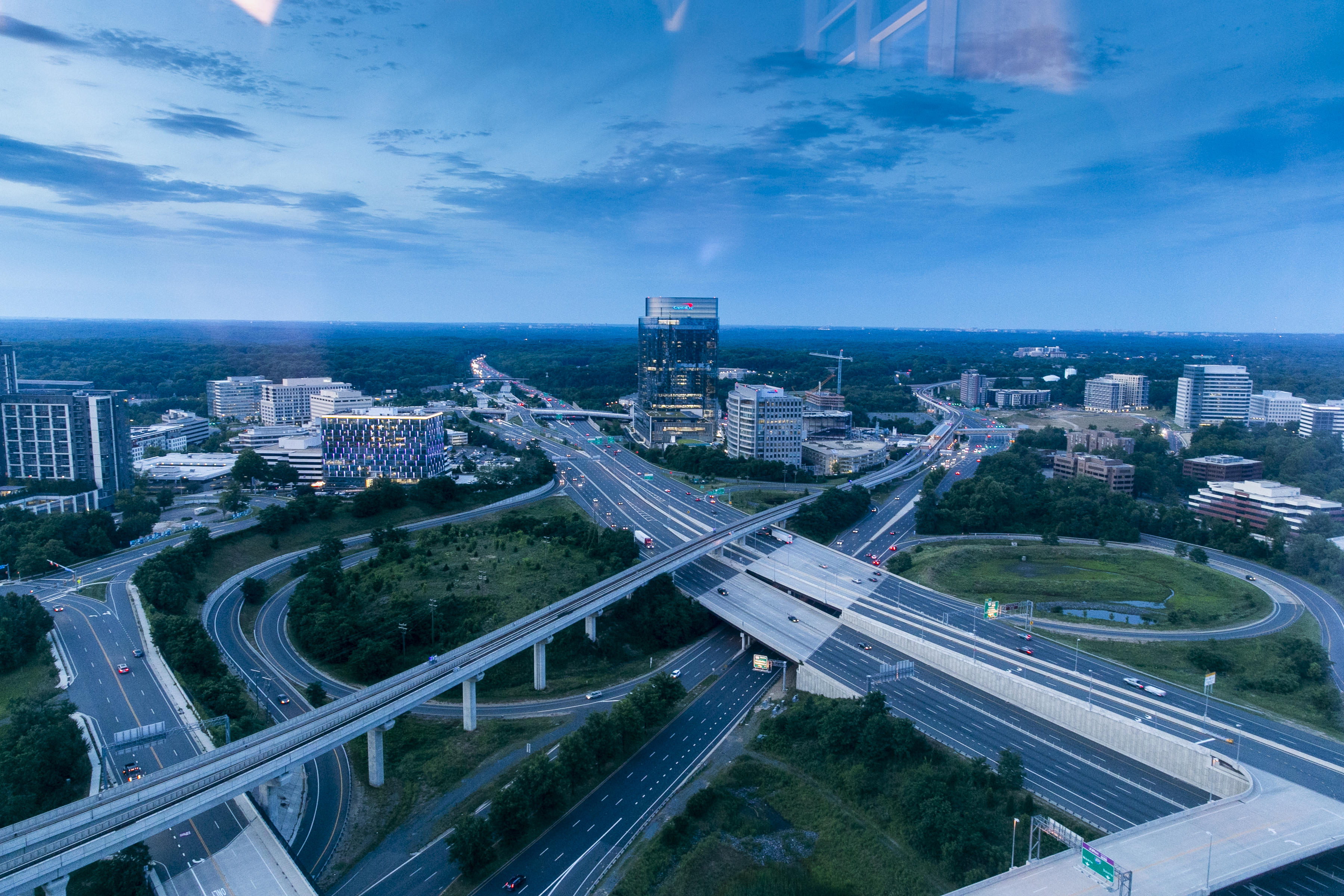 An aerial shot of a skyline with interstate highways in front