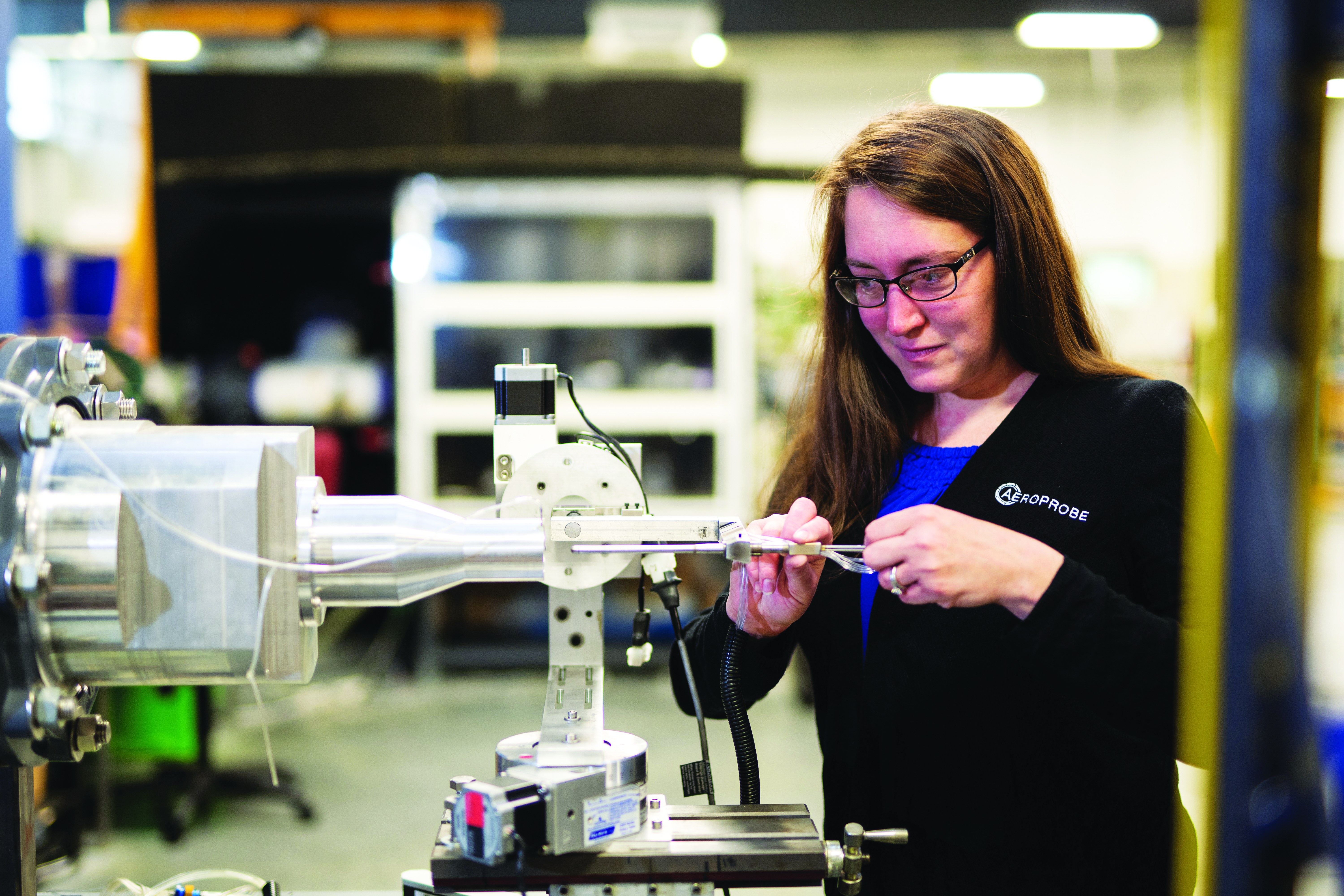 A woman working on a piece of aerospace equipment