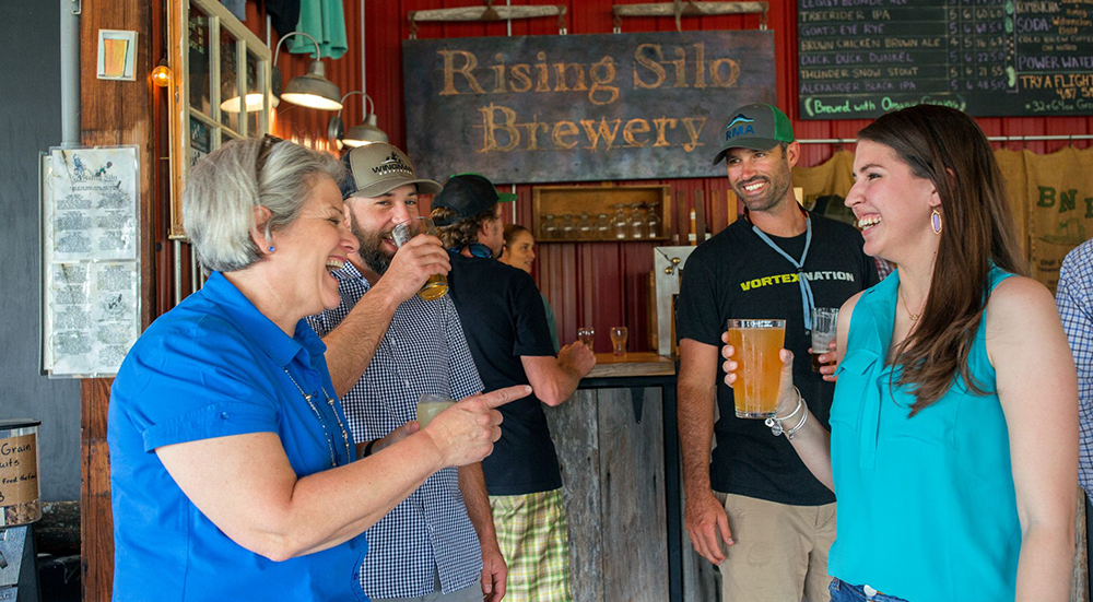 A group of people drinking beer at Rising Silo Brewery