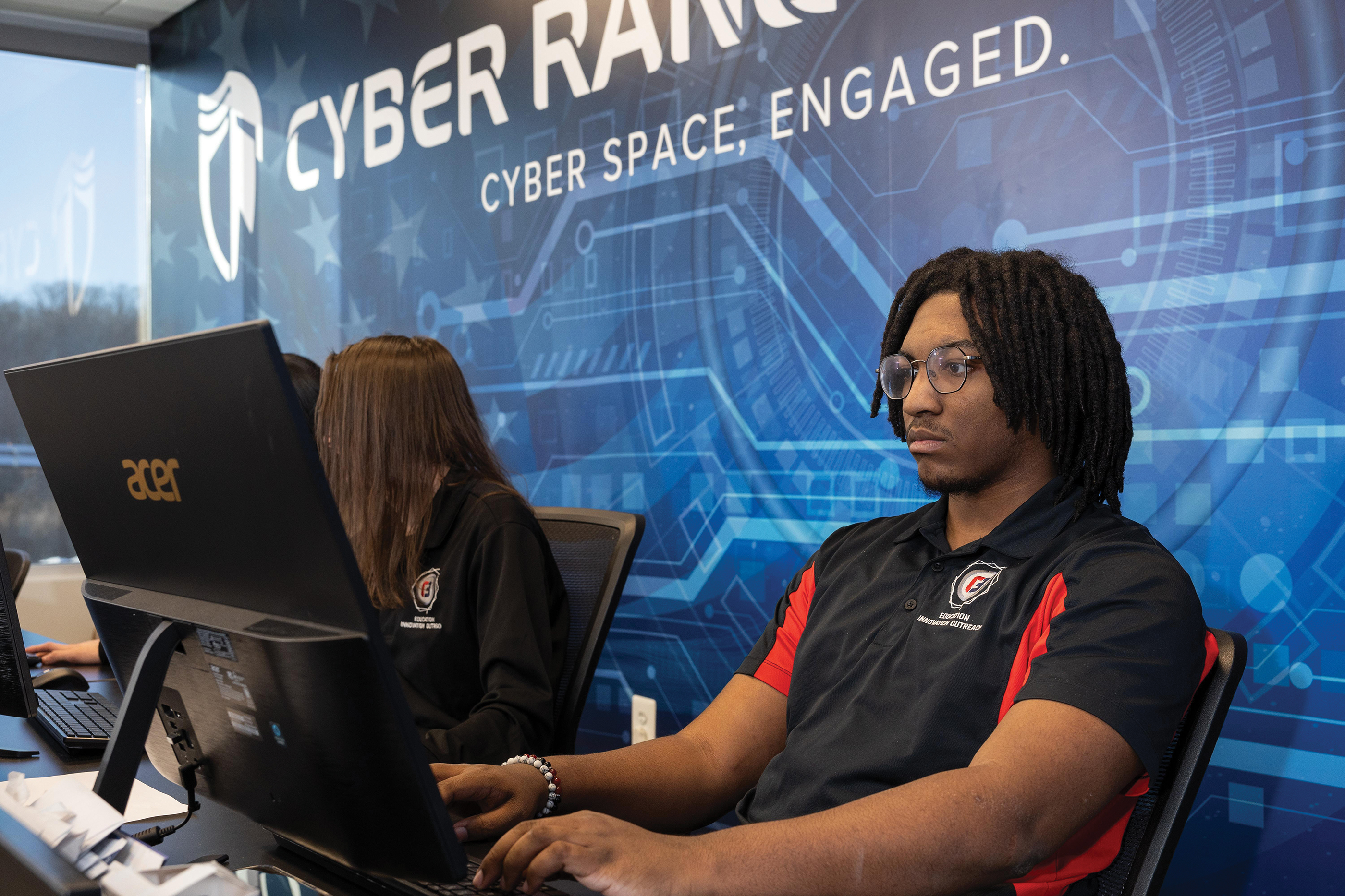 Two students sitting in front of a computer 