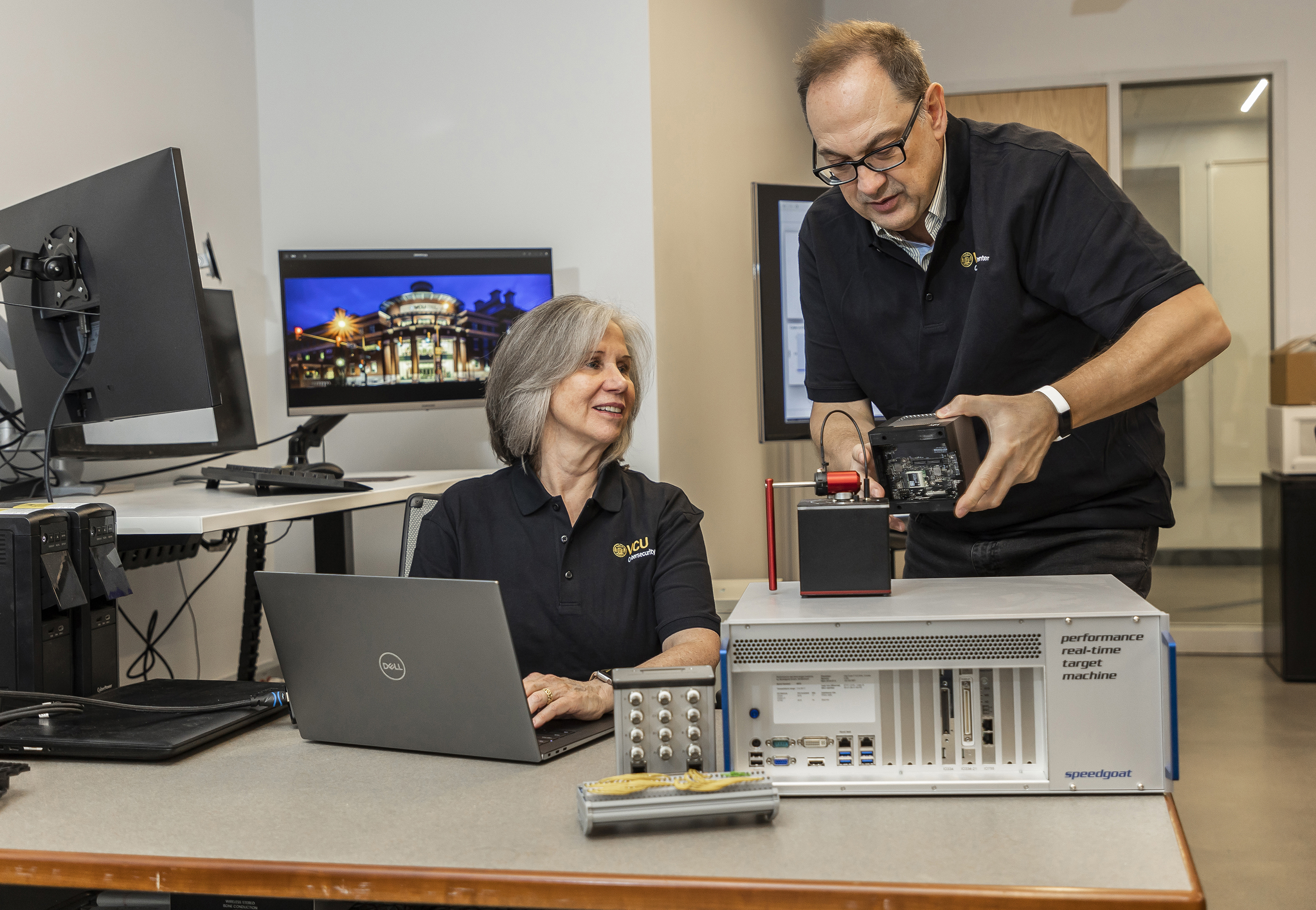 Two VCU Cybersecurity students working on a computer