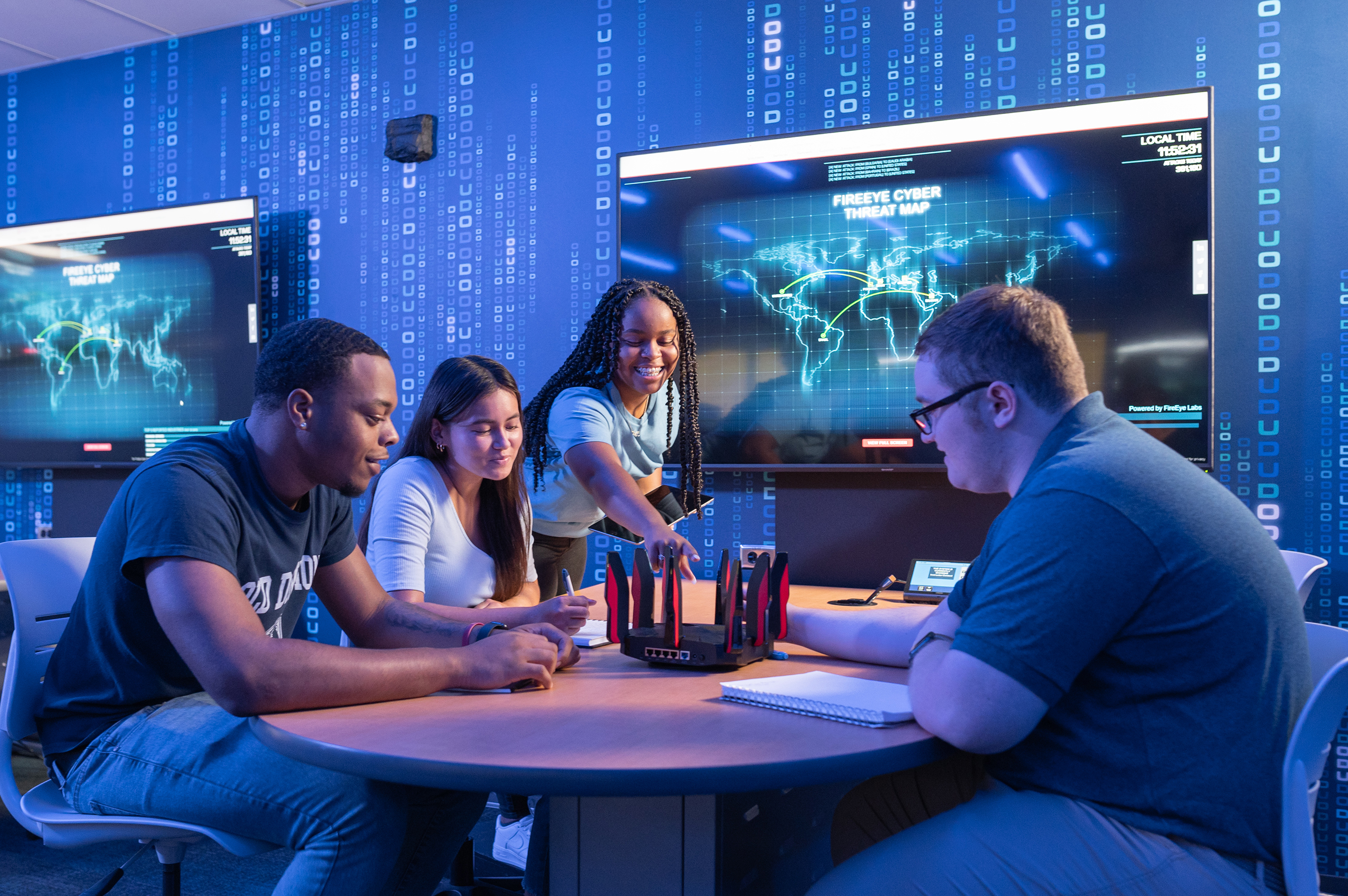 4 ODU School of Cybersecurity Students sitting around a table