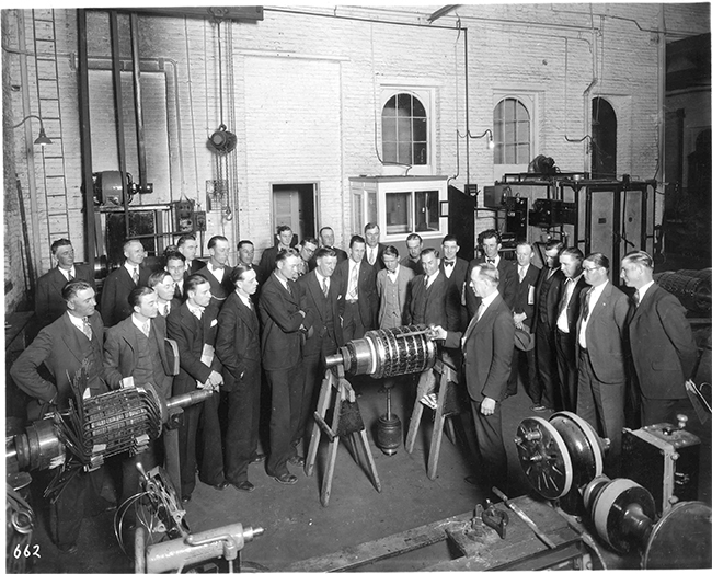 Engineers and officials from the Virginia Electric and Power Company observe what was then a state-of-the-art generator
