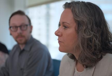 Photo of two employees at a conference table