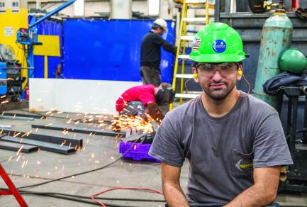 Acoustical Sheetmetal employee wearing a hard hat