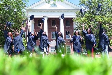College graduates throwing their caps