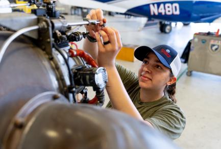 A woman repairing an airplane