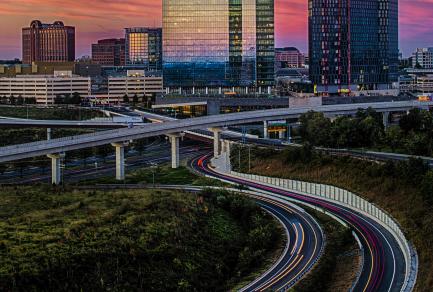A picture of an urban skyline behind an interstate
