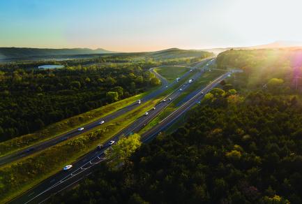 An aerial shot of an interstate highway at sunrise