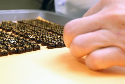 A closeup of a hand working with small objects