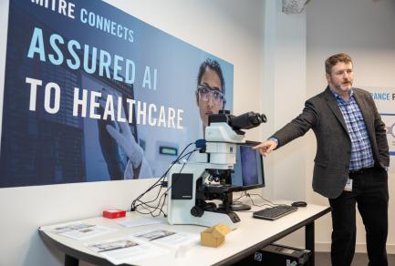 A man pointing at a computer
