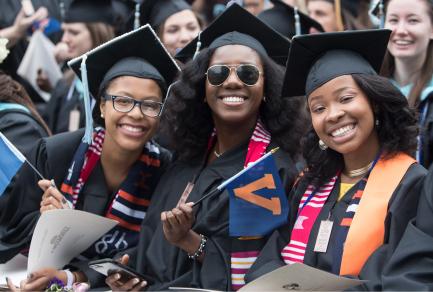 Three women in graduation caps and gowns