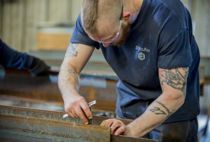 A man working on a metal beam