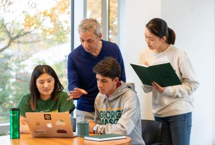 Prof. James Baldo works with graduate students