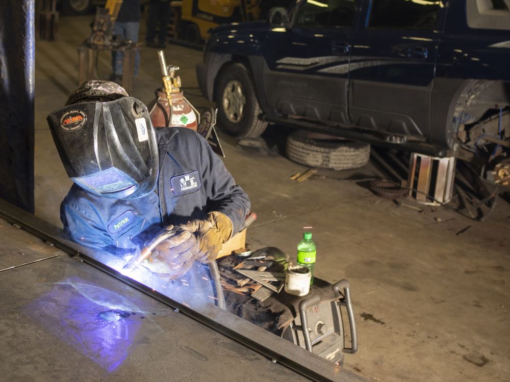 Photo of a man using a welding tool
