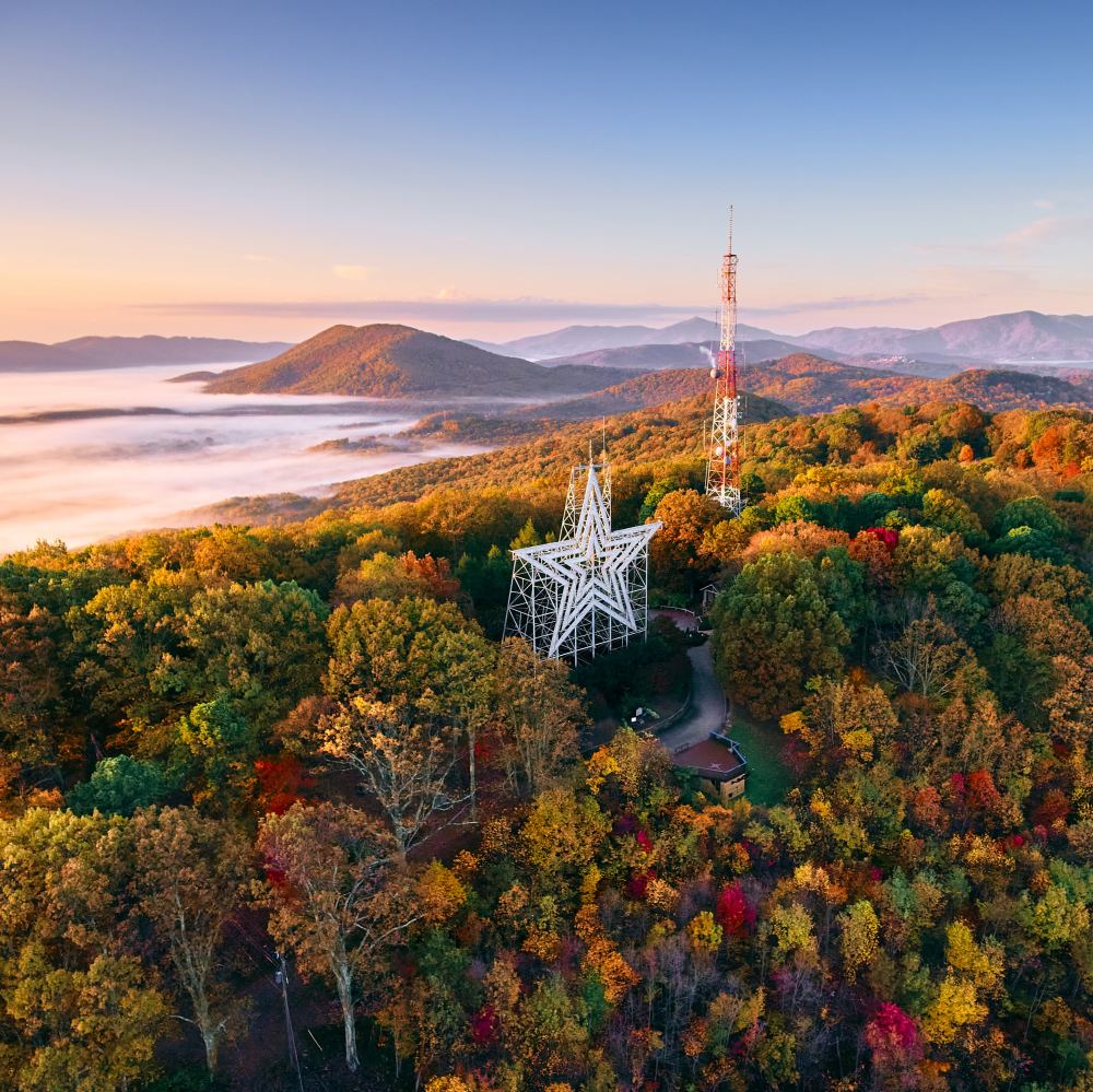 Roanoke Star seen among fall leaves and fog rolling onto the Mountains 