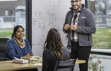 Sunta Dodani, M.D., Ph.D., left, meets with staff of the EVMS-Sentara Healthcare Analytics and Delivery Science Institute (HADSI)