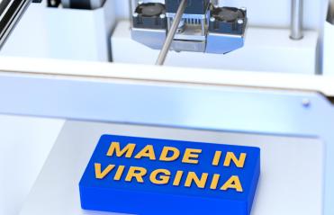 A 3D printer makes a sign that reads "Made in Virginia."