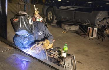 Photo of a man using a welding tool