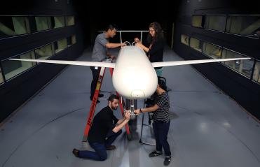 Four people working on a plane to support the NASA Langley partnership