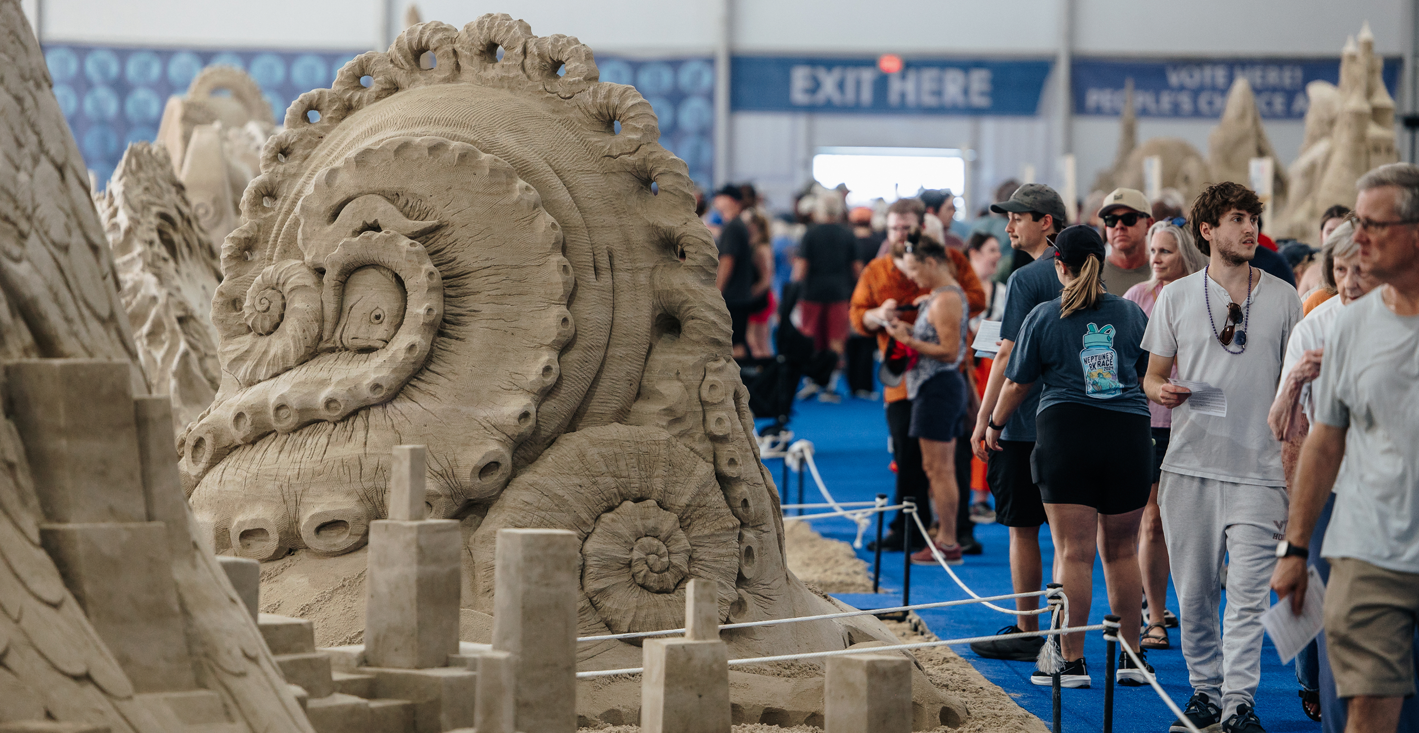 People viewing a sand sculpture