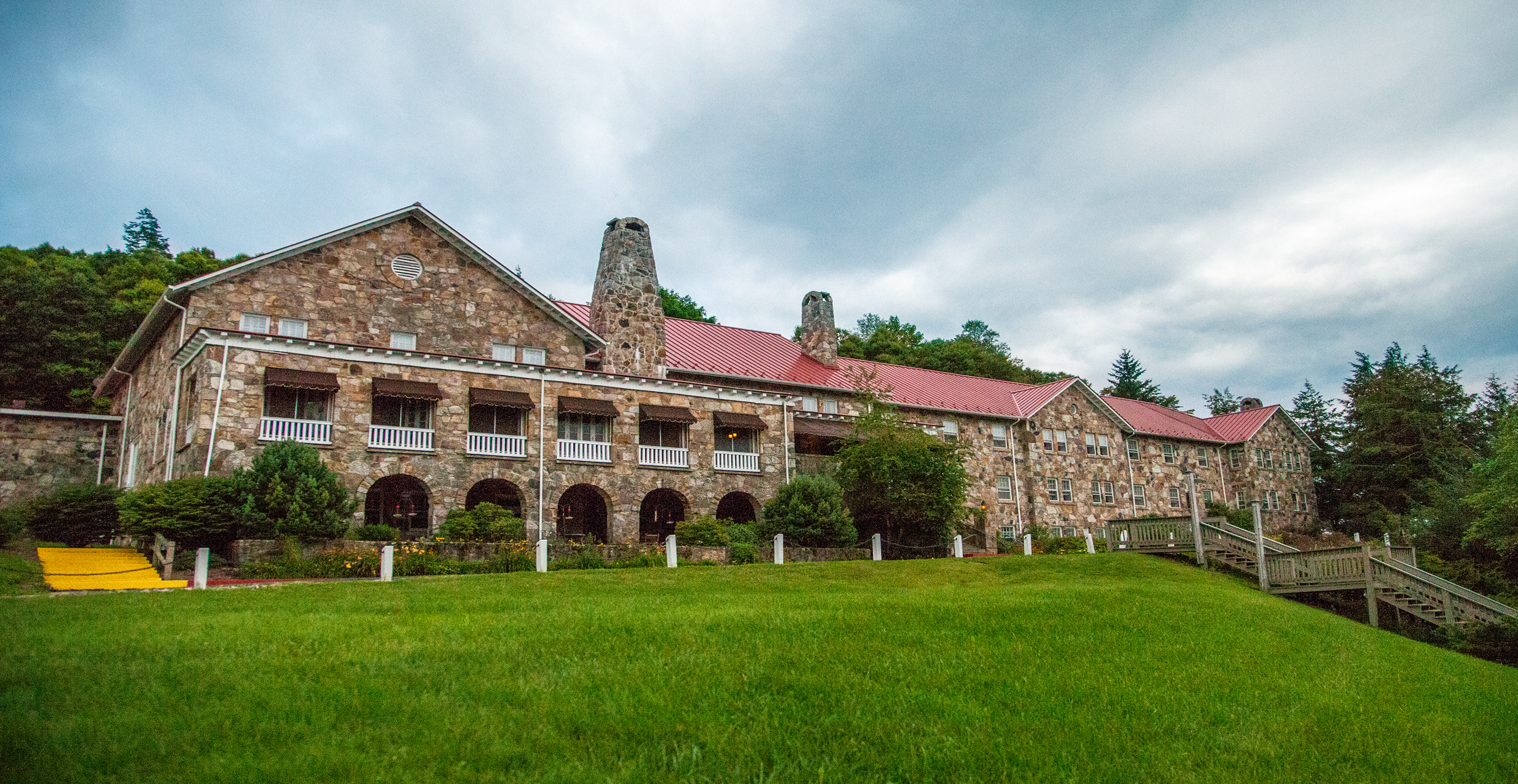 A stone lodge on top of a grassy hill