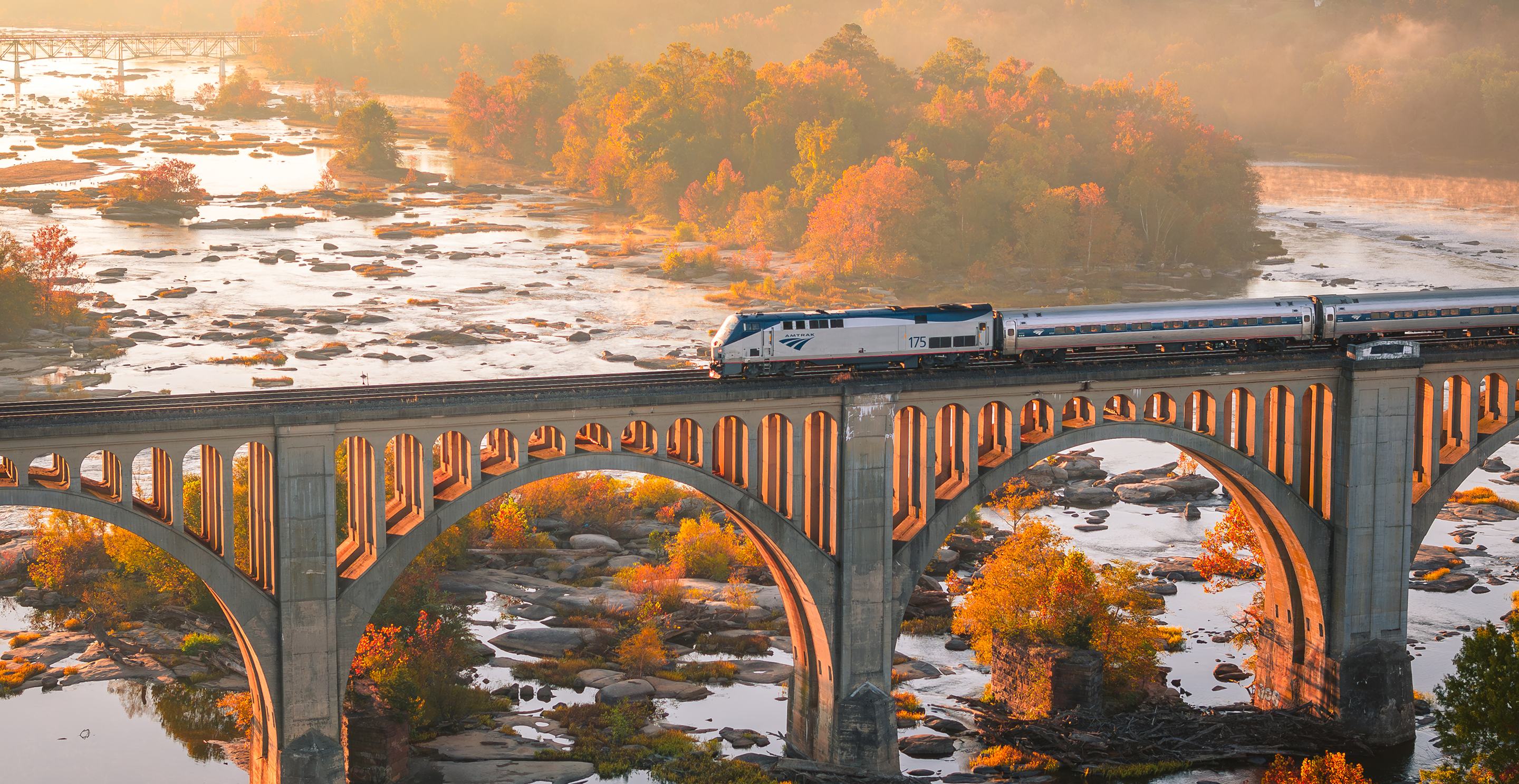 Train crossing a bridge over a river