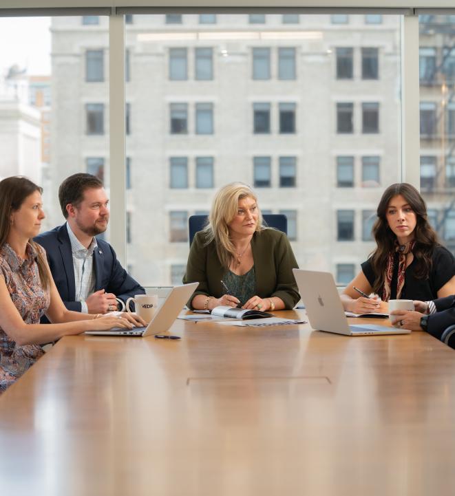 Photo of VEDP staff at a conference table