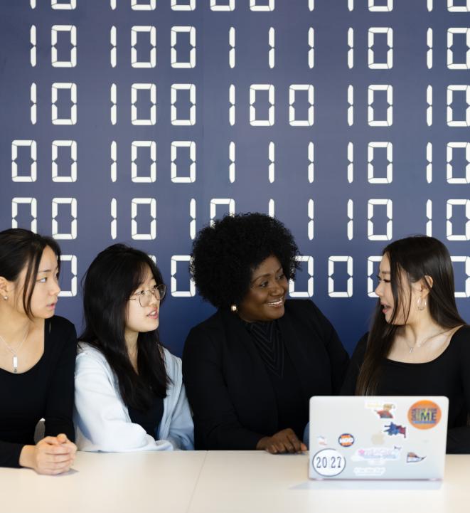 Five University of Virginia Students looking at a laptop
