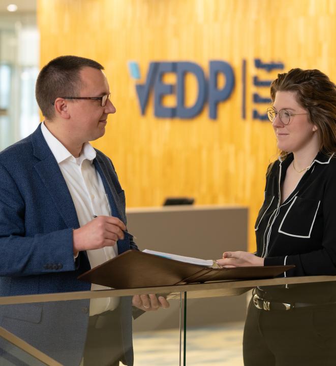 Photo of two VEDP employees talking