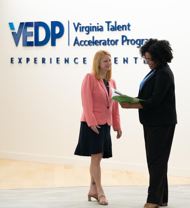 VEDP Staff looking at a magazine