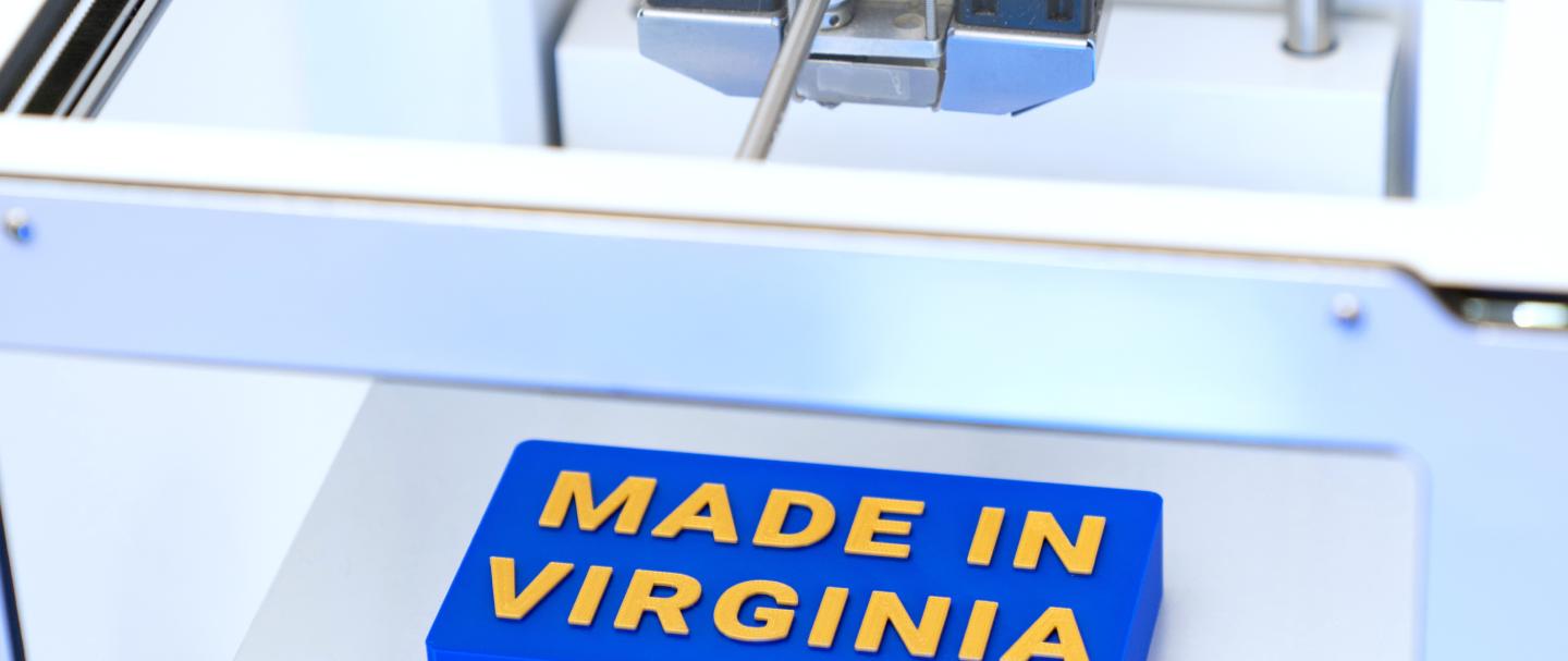A 3D printer makes a sign that reads "Made in Virginia."