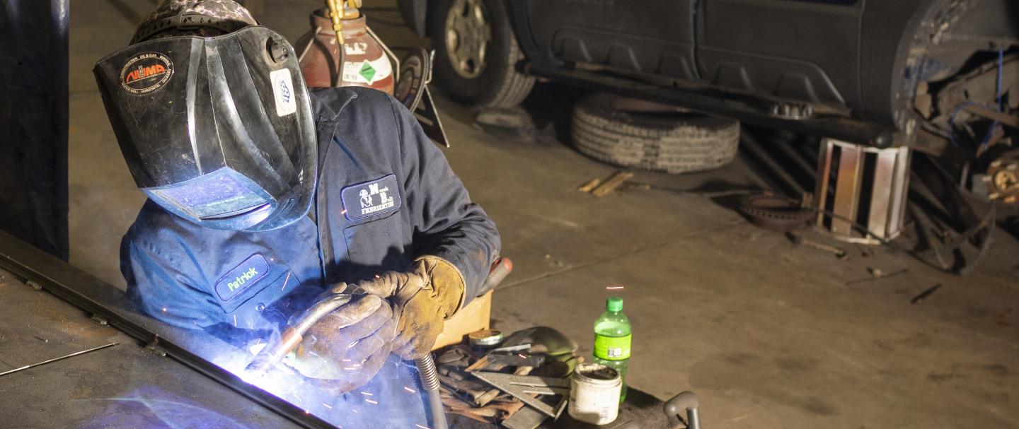 Photo of a man using a welding tool