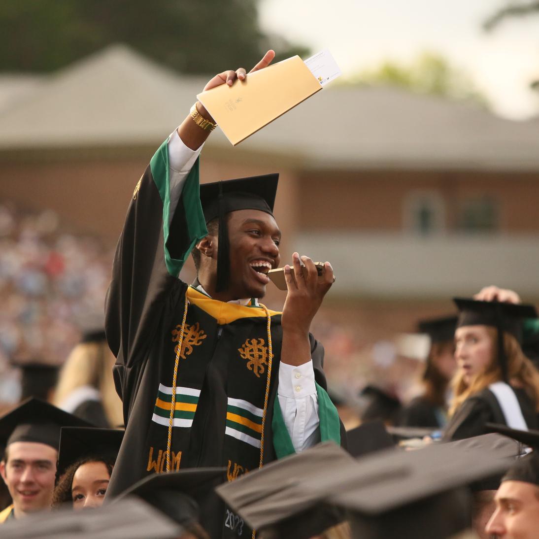 College graduate holding diploma