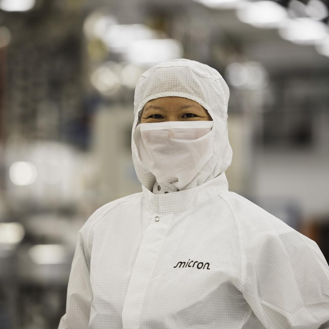 A woman in protective equipment looking at the camera