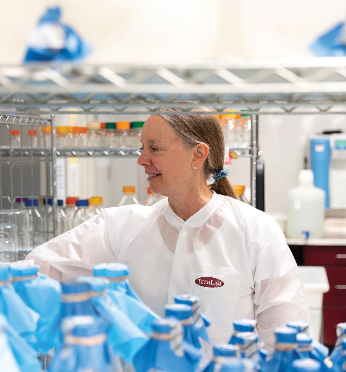 A TECHLAB employee in a lab coat 