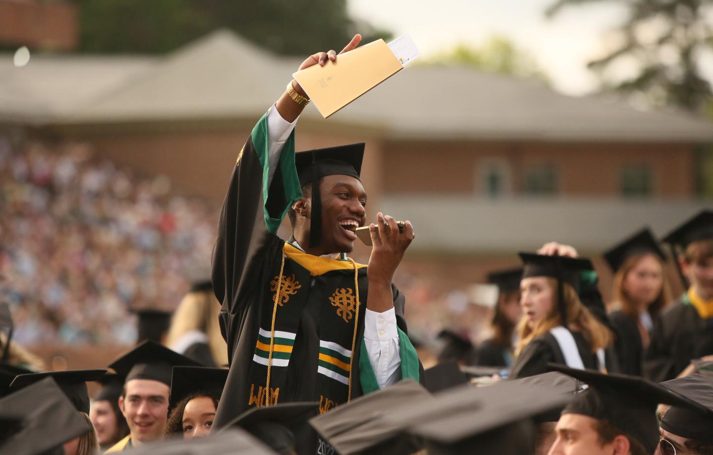 College graduate holding diploma
