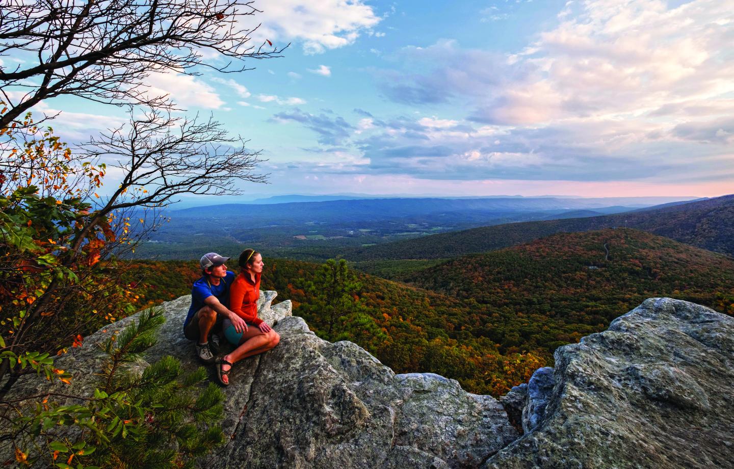 Photo of two hikers overlooking a mountain