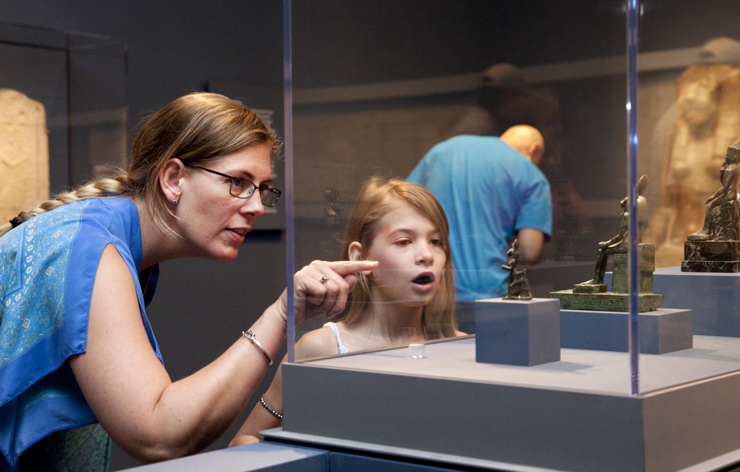 Two family members look at a sculpture on display in the Chrysler Museum of Art.