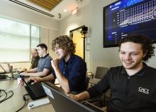 Three employees of CACI work on project-based learning initiatives. 
