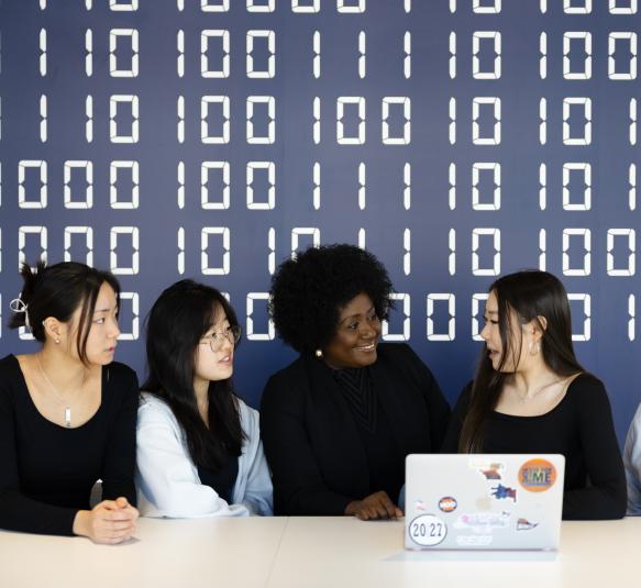 Five University of Virginia Students looking at a laptop