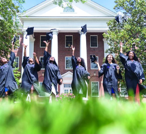 College graduates throwing their caps