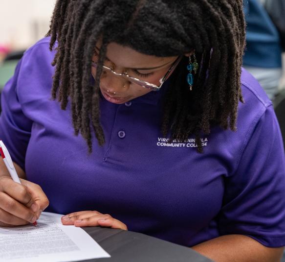 A woman writing in a notebook