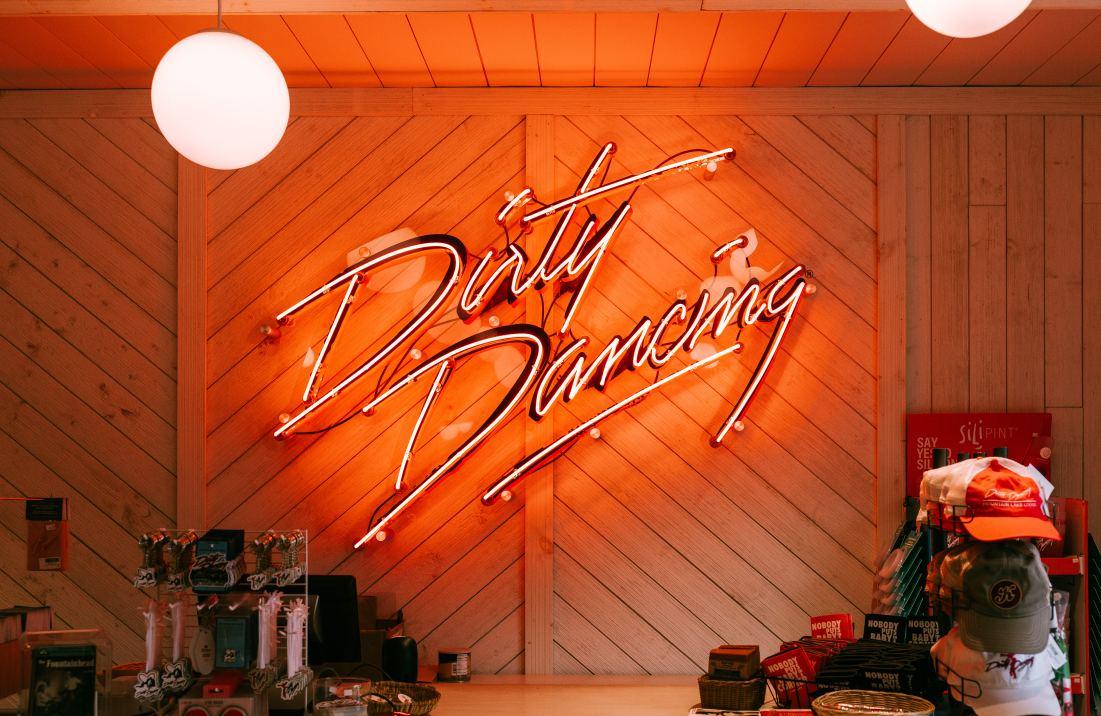 Neon sign that says "Dirty Dancing" over a bar