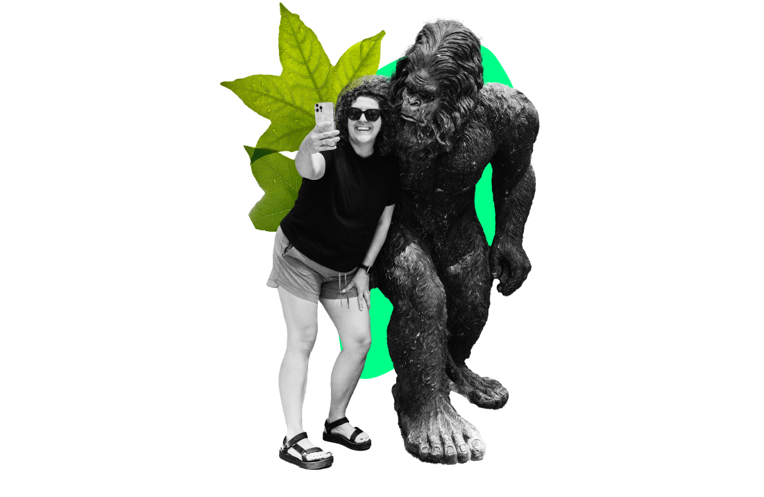 Woman taking a selfie with a Bigfoot statue