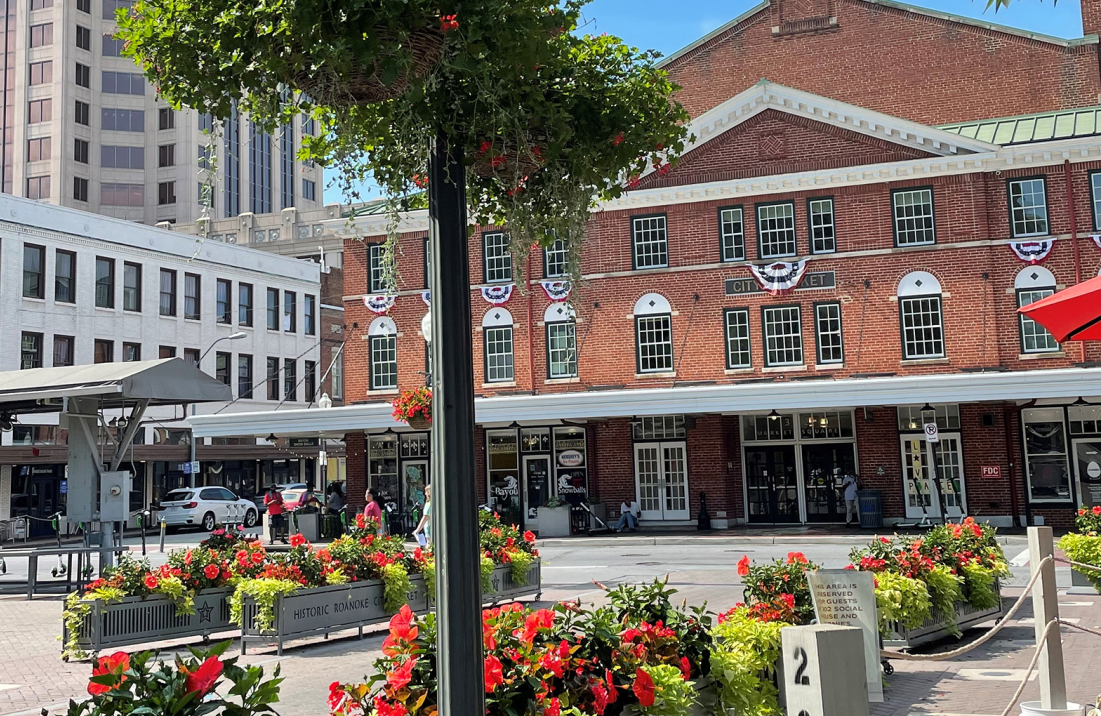 Historic downtown square with brick buildings and flower planters