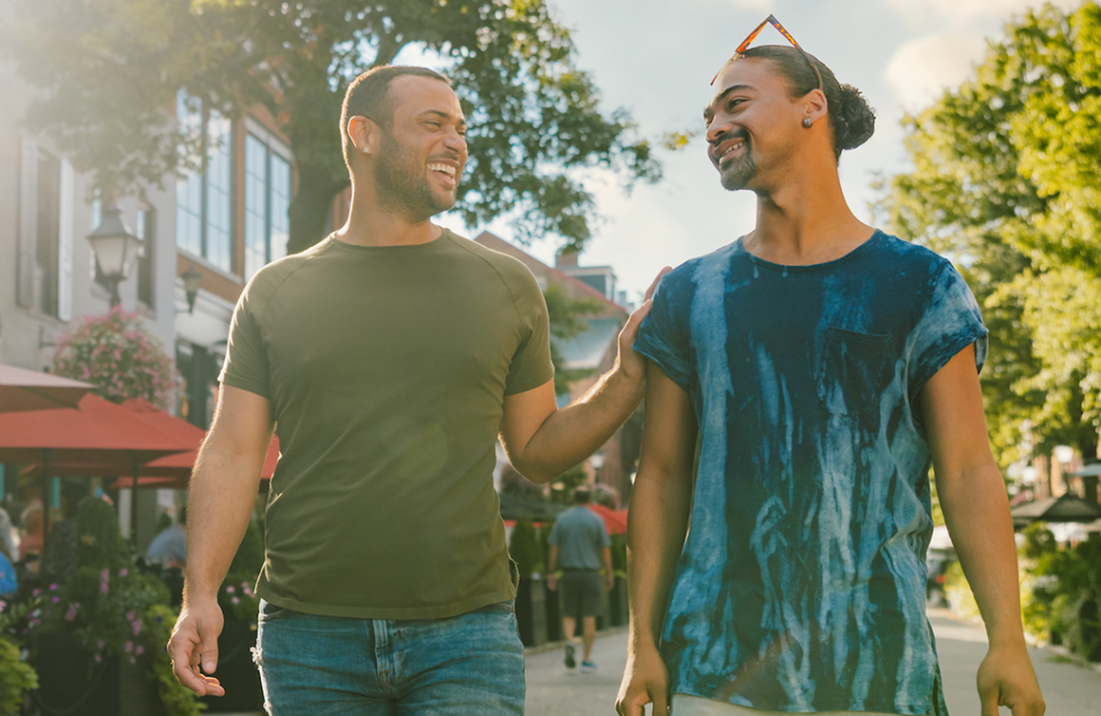 Two people walking together through a lively Alexandria neighborhood