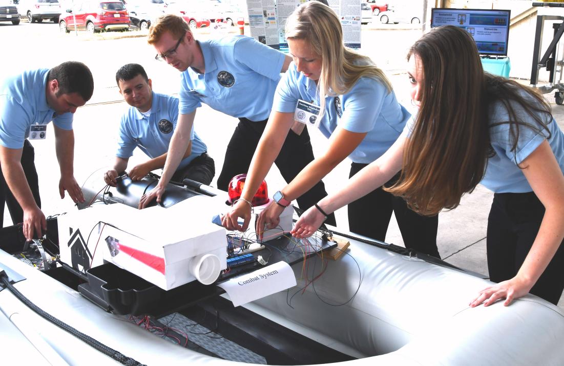 Students working on a naval boat