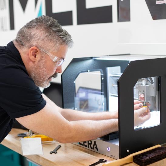 Man opperates 3D printer